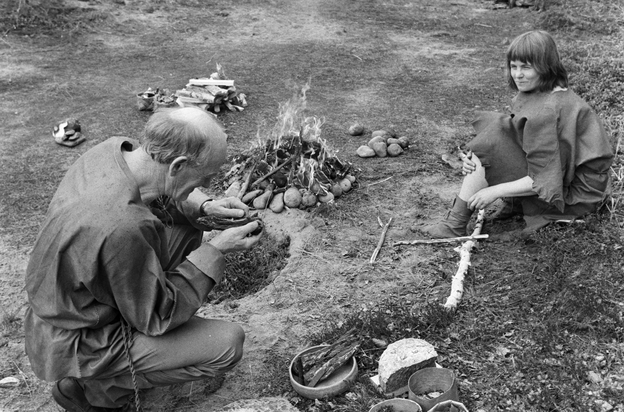 Stig skär torrkött med stenkniv och Siw Andersson sitter till höger, 1988. SM H 0662 04. Foto: Lilian Andersson och Maria Löfgren/Skellefteå museum.